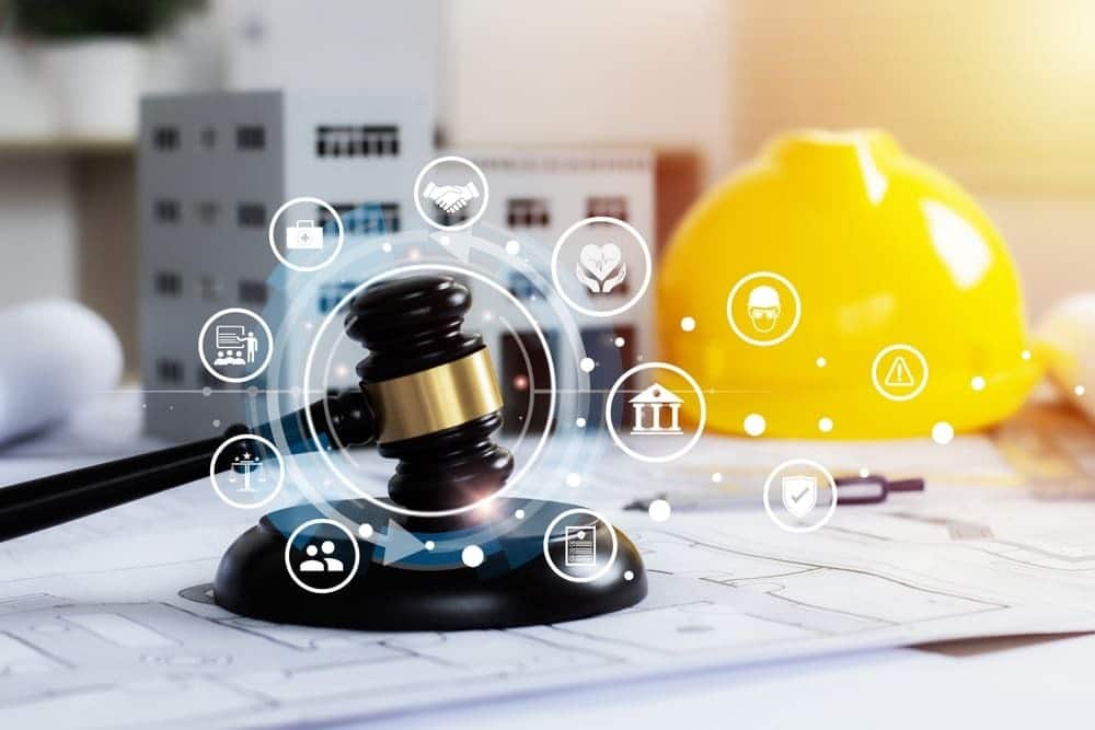 Judge’s gavel and yellow hard hat on construction blueprints, representing a New York construction accident claim and injured workers’ legal rights.