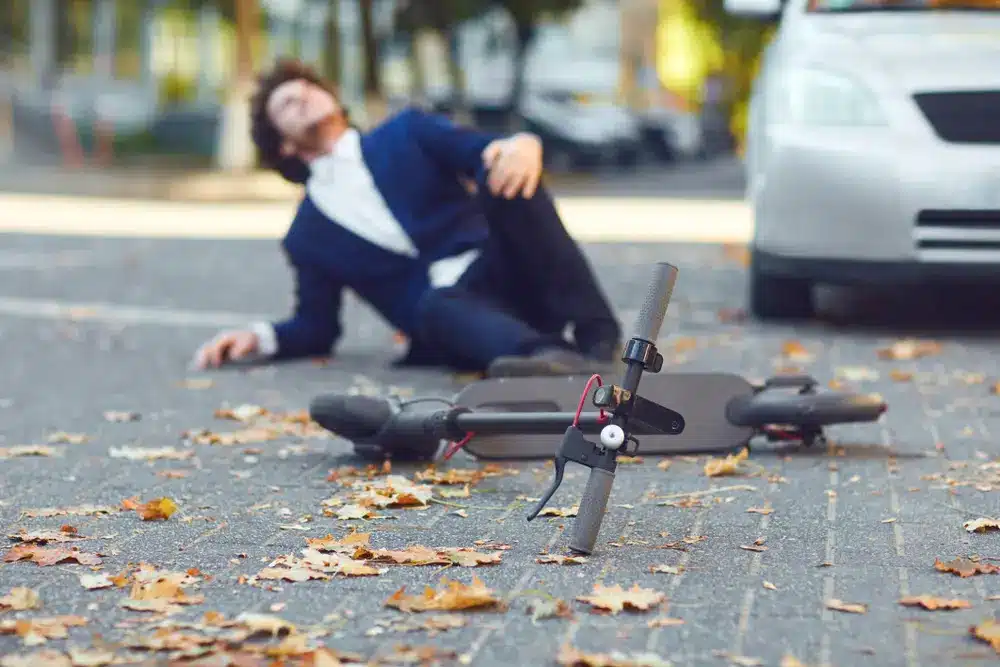 A damaged e-bike and electric scooter on the road after a minor traffic accident, highlighting the importance of rider safety and awareness.
