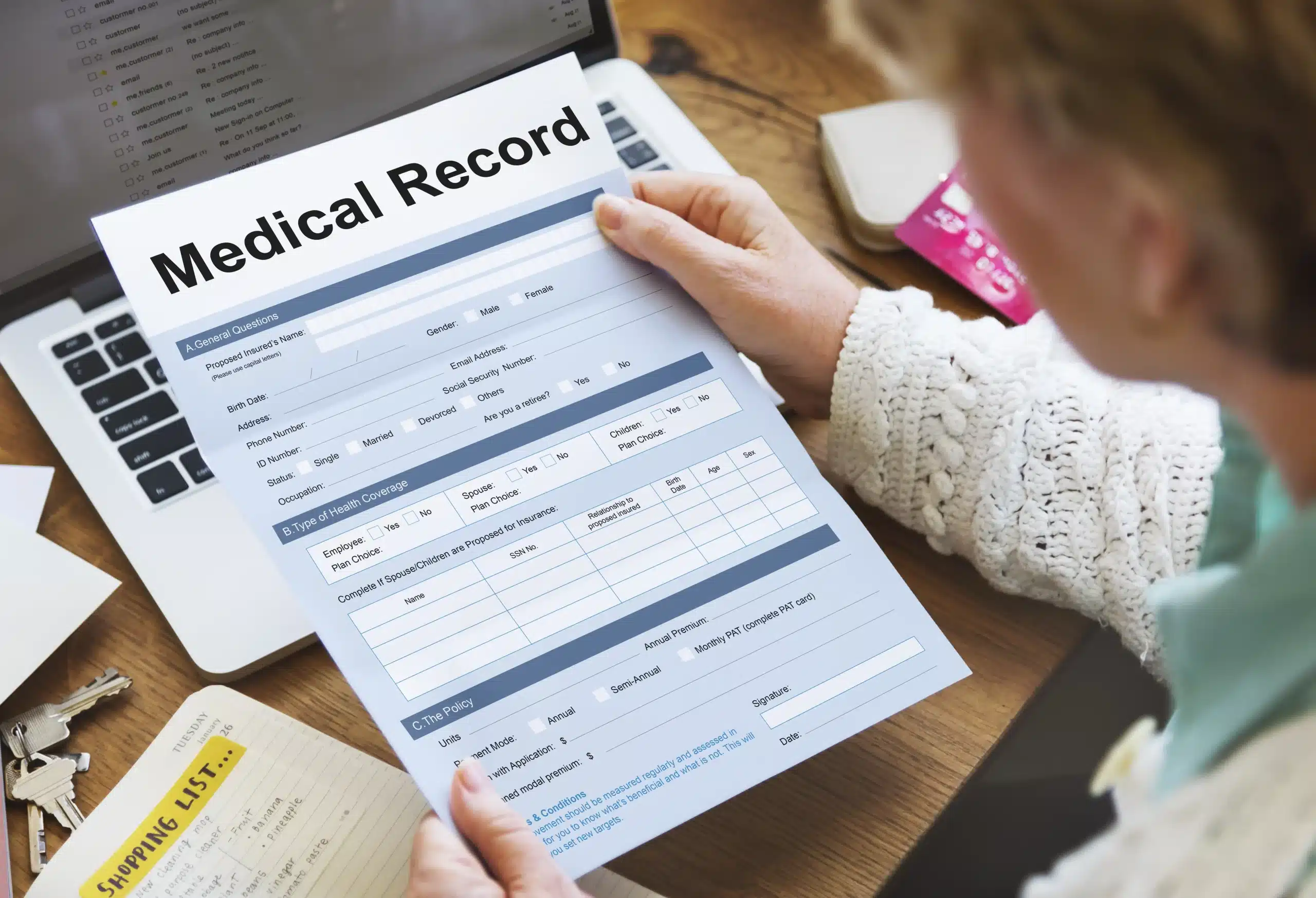 Open medical file showing diagnosis report, treatment notes, and hospital invoice on a lawyer’s desk for New York personal injury case